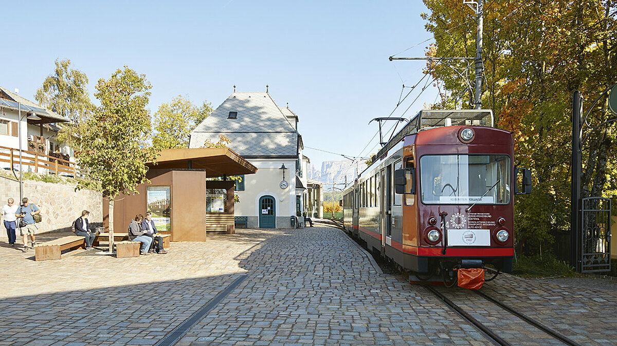 People waiting at the Soprabolzano/Oberbozen station of the Renon/Ritten light railway