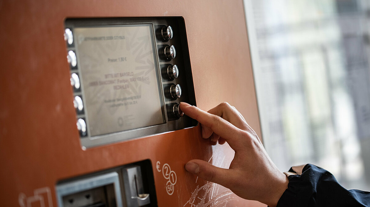 Detail of a hand of a person, choosing an option at a ticket machine